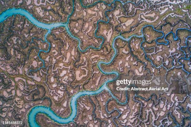 high angle view looking down on marshlands, england, united kingdom - high tide stock-fotos und bilder