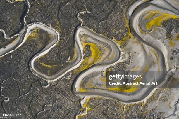 drone image of marshland patterns, wales, united kingdom - watershed 2017 stock pictures, royalty-free photos & images