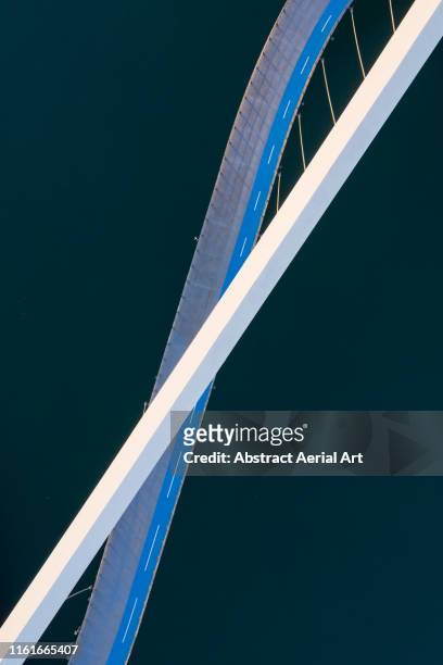 minimal shot of a bridge crossing a river taken by drone, united arab emirates - dubai bridge stock pictures, royalty-free photos & images
