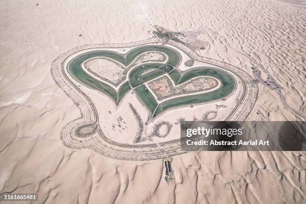 aerial shot of al qudra lakes, dubai, united arab emirates - coeur symbole dune idée photos et images de collection