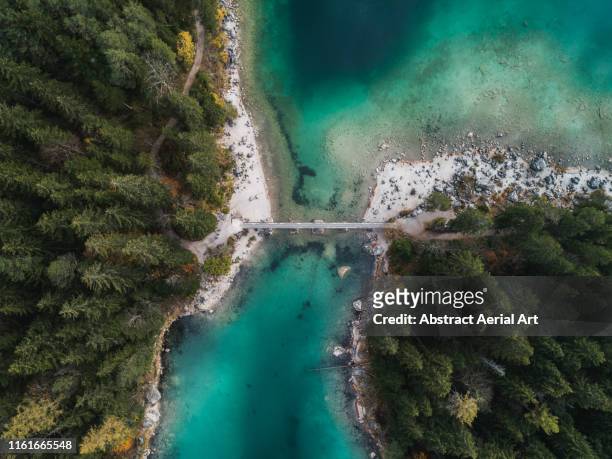 high angle view of bridge over section of lake eibsee, bavaria, germany - bridge abstract stock-fotos und bilder