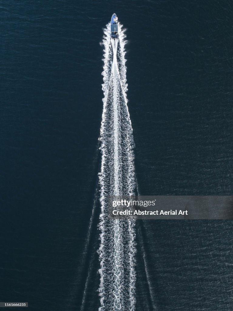 Aerial image of a speed boat moving quickly across the ocean, Hong Kong