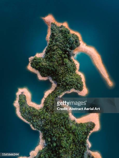 aerial shot of unique shaped island with a forest, hong kong - insel stock-fotos und bilder