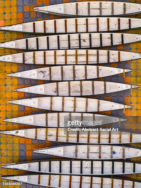 abstract shot of a row of empty kayaks taken with a drone, hong kong - china balance stock pictures, royalty-free photos & images