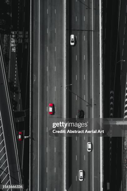 red taxi shot by drone on a hong kong highway - higher return stock pictures, royalty-free photos & images