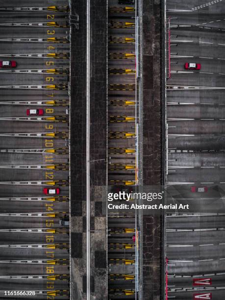 Looking down on a toll booth with red taxis on the highway, Hong Kong