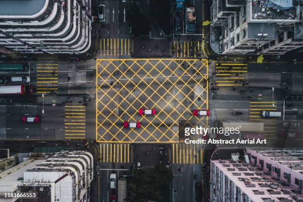 taxis on a city road intersection, kowloon, hong kong - aerial hong kong stock-fotos und bilder