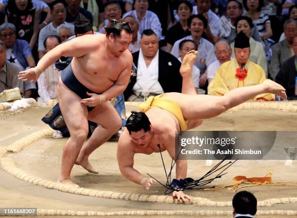 Mongolian yokozuna Kakuryu throws Endo to win on day six of the Grand Sumo Nagoya Tournament at the Dolphins Arena on July 12, 2019 in Nagoya, Aichi,...