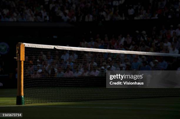 The net and net post on Centre Court during the semi final match between Roger Federer of Switzerland and Rafael Nadal of Spain during Day Eleven of...