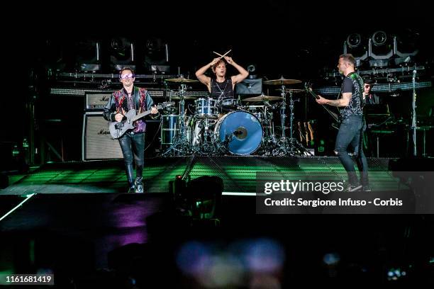 Matthew Bellamy, Dominic Howard and Chris Wolstenholme of Muse perform at the San Siro Stadium on July 12, 2019 in Milan, Italy.