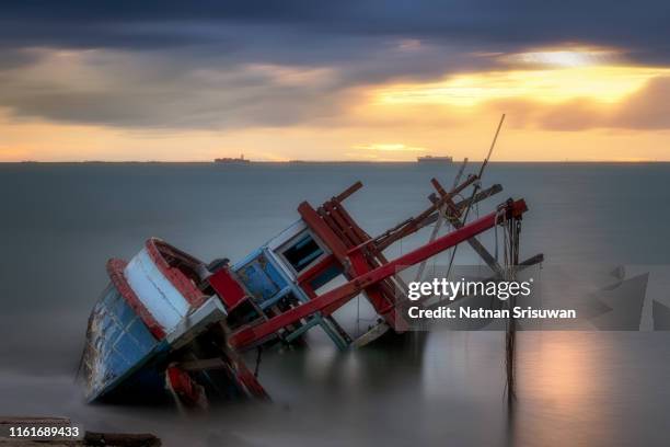 old shipwreck on the beach. - capsizing stock pictures, royalty-free photos & images