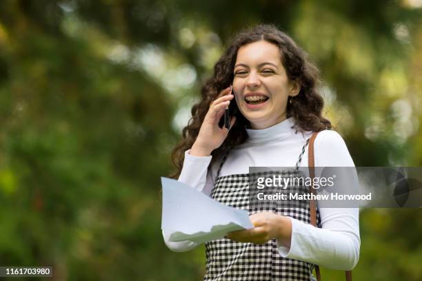 Cerys Hughes smiles while on the phone after receiving her A Level results at Ffynone House School on August 15, 2019 in Swansea, Wales. UCAS...