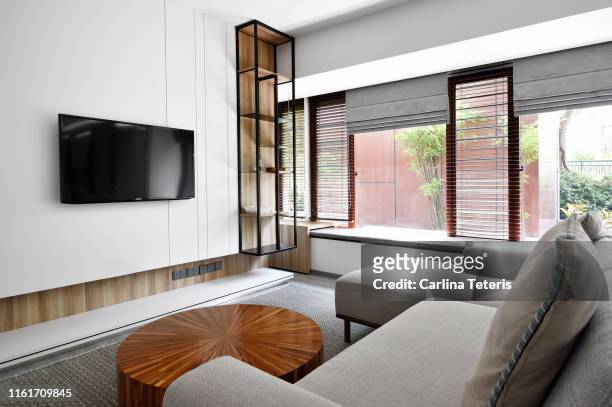 contemporary condo living room - wall of tvs stock pictures, royalty-free photos & images