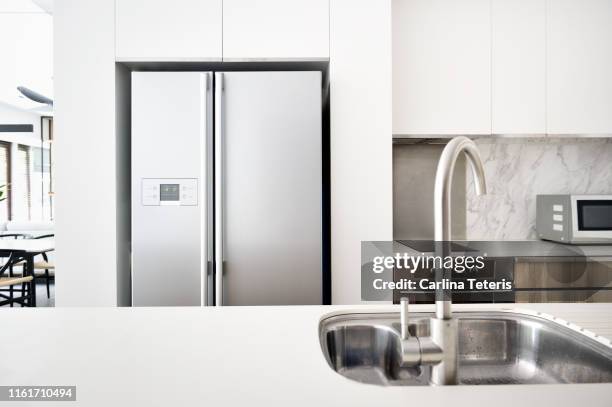 kitchen in a modern luxury condo - kitchen refrigerator stock pictures, royalty-free photos & images