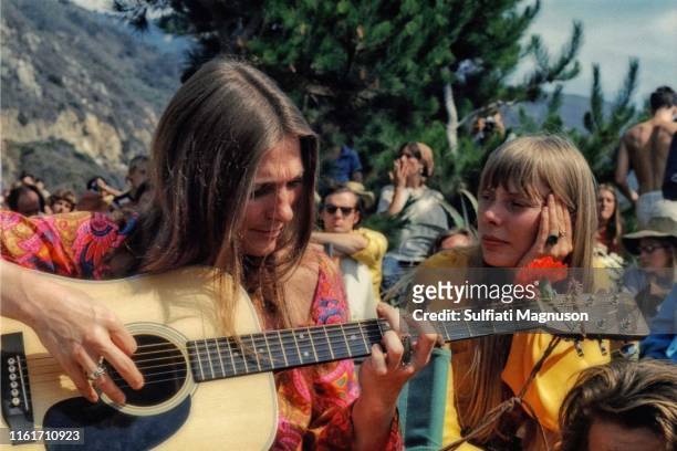 Judy Collins and Joni Mitchell "back stage" , Judy playing her guitar, and Joni with chin in hand, listening. Big Sur Hot Springs, later Escalen...