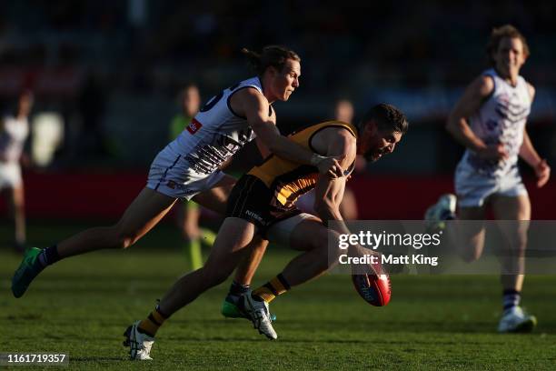 Ricky Henderson of the Hawks is tackled by Ed Langdon of the Dockers during the round 17 AFL match between the Hawthorn Hawks and the Fremantle...