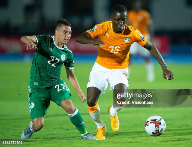 Max Gradel of Ivory Coast is tackled by Ismael Bennacer of Algeria during the 2019 Africa Cup of Nations quarter-final match between Ivory Coast and...