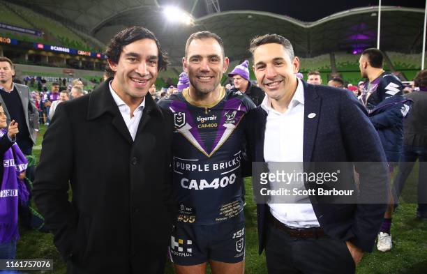 Melbourne Storm Captain Cameron Smith poses with Johnathan Thurston and Billy Slater as he leaves the field after becoming the first player to reach...