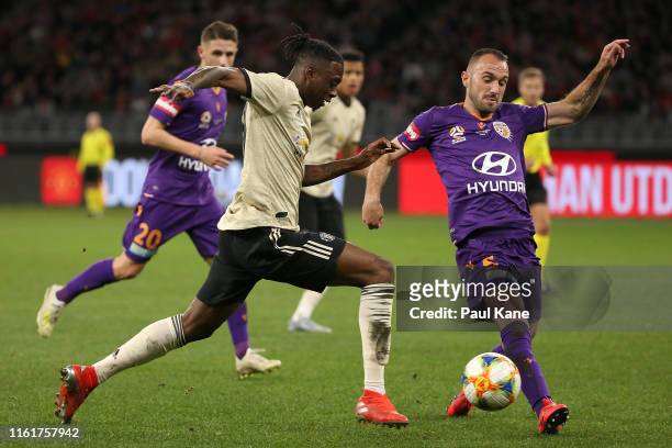 Aaron Wan-Bissaka of Manchester United is challenged by Ivan Franjic of the Glory during the match between the Perth Glory and Manchester United at...