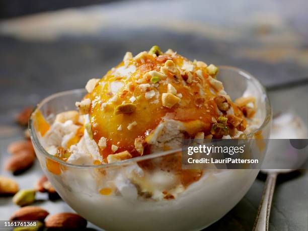 vegan, coconut milk vanilla ice cream sundae with caramel sauce and chopped nuts - almond caramel stock pictures, royalty-free photos & images