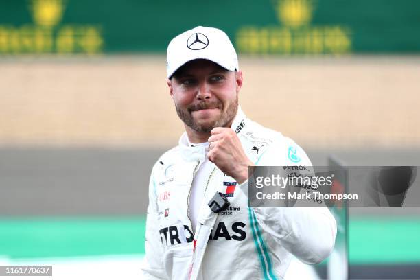 Pole position qualifier Valtteri Bottas of Finland and Mercedes GP celebrates in parc ferme during qualifying for the F1 Grand Prix of Great Britain...