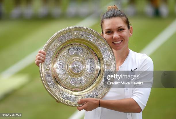 Simona Halep of Romania pose for a photo with her trophy after winning the Ladies' Singles final against Serena Williams of The United States during...