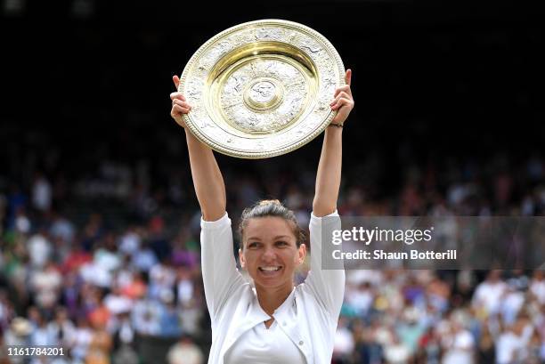 Simona Halep of Romania lifts the trophy after winning the Ladies' Singles final against Serena Williams of The United States during Day twelve of...