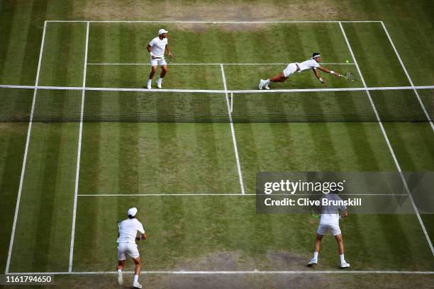 General view as Robert Farah of Colombia, playing partner of Juan Sebastian Cabal of Colombia dives to play a backhand in their Men's Doubles final...