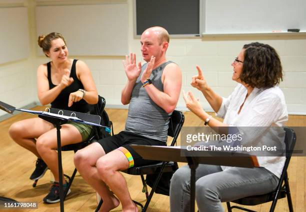 Sign language interpreters Mandy Welly, Michael Creason and Christina Whitehouse-Suggs act out their parts during a rehearsal for the musical "Dear...