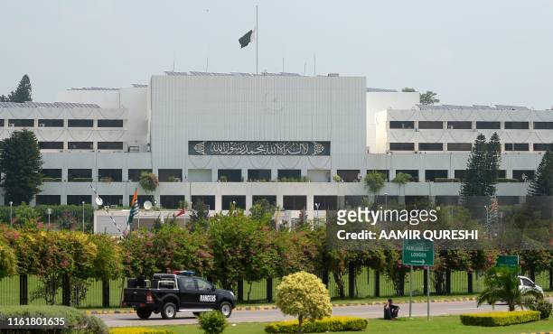 Pakistani national flag flies at half-mast on the Parliament building in Islamabad on August 15 as the country observes 'Black Day' on India's...