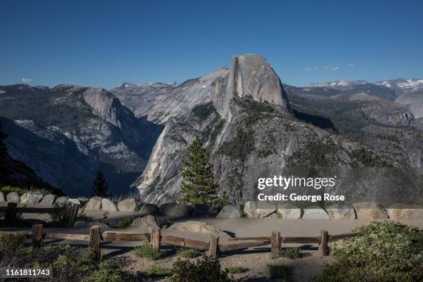 The granite features of Half Dome are viewed from Glacier Point on July 1 in Yosemite Valley, California. With the arrival of summer, visitors are...