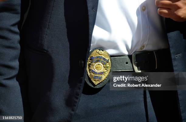 New Mexico State Police officer, wearing his badge on his belt, functioned as a bodyguard to Michelle Lujan Grisham, the governor of New Mexico, as...