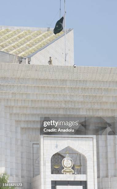 Pakistani flag flies at half-mast at Supreme Court building as the country observes "Black Day" to mark India's Independence Day after it revoked the...