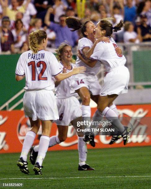 Members of the US team celebrate Joy Fawcett's goal that put the US up 3-2 01 July 1999 during the second half of the quarter-final match of the...