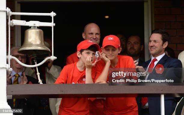 Andrew Strauss and his sons Luca and Sam wait to ring the five minute bell on Ruth Strauss day, the second day of the second Specsavers test match...