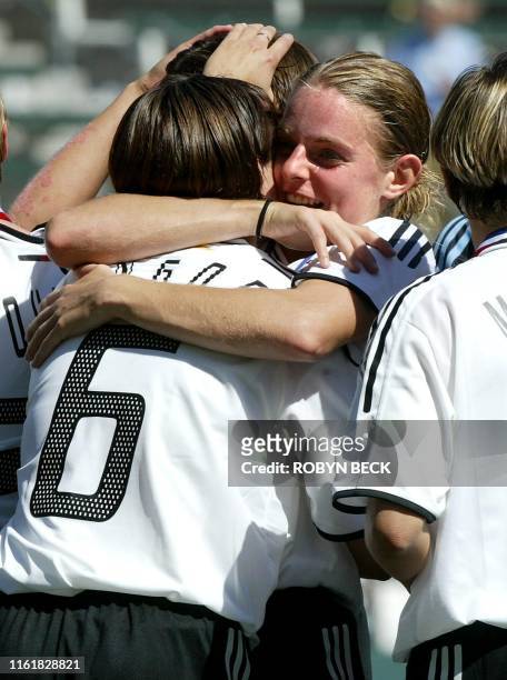 Germany's Nia Kuenzer hugs teammate Renate Lingor after Germany defeated Sweden 2-1 in the final at the FIFA 2003 Women's World Cup, 12 October 2003...