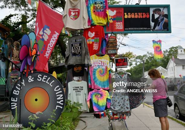 Person looks at Woodstock souvenirs outside a store on Tinker Street on August 14, 2019 in Woodstock, New York. - The town of Woodstock -- a...