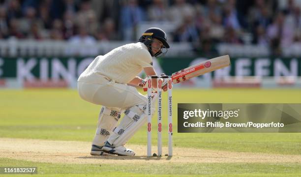 Chris Woakes of England is hit on the helmet during the second day of the second Specsavers test match between England and Australia at Lord's on...