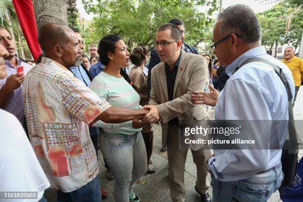 August 2019, Venezuela, Caracas: Jorge Arreaza , Venezuelan foreign minister, shakes hands with a supporter as he comes to an event against the...