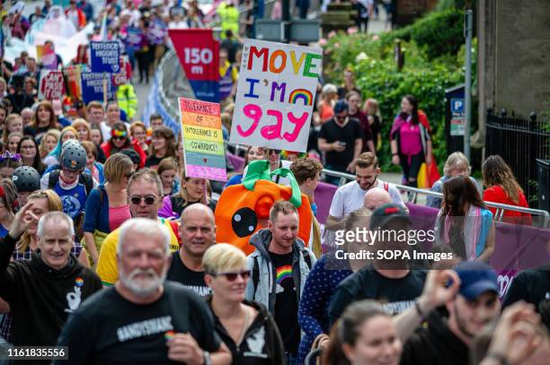 Members of the march are seen holding signs and banners at the Perthshire Pride. Perth plays host to the event Perthshire Pride, an annual event for...