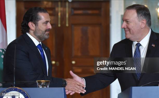 Secretary of State Mike Pompeo and Lebanon's Prime Minister Saad Hariri shake hands as they speak to the press following a meeting at the State...