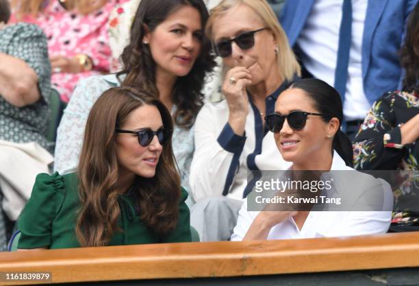 Catherine, Duchess of Cambridge and Meghan, Duchess of Sussex in the Royal Box on Centre Court during day twelve of the Wimbledon Tennis...