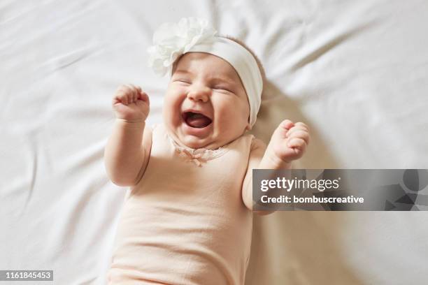 cute little baby girl laughing - pink hat stock pictures, royalty-free photos & images