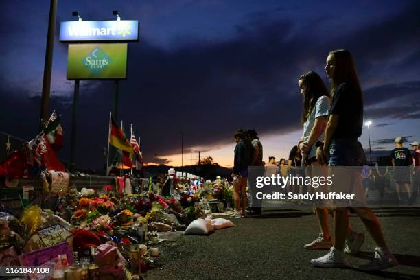 People gather at a makeshift memorial honoring victims outside Walmart August 15, 2019 in El Paso, Texas. 22 people were killed in the Walmart during...