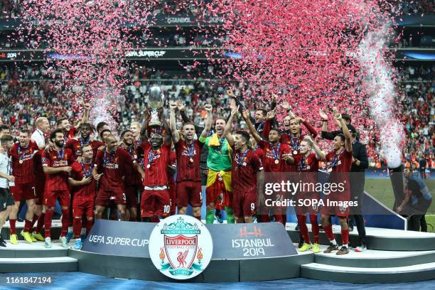 Sadio Mane of Liverpool lifts the trophy with his team-mates at the end of the UEFA Super Cup match between Liverpool and Chelsea at Vodafone Park. .