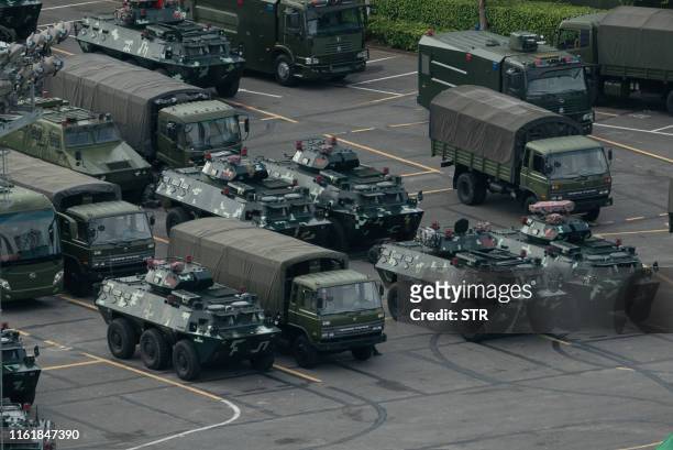Trucks and armoured personnel carriers are seen parked at the Shenzhen Bay stadium in Shenzhen, bordering Hong Kong in China's southern Guangdong...