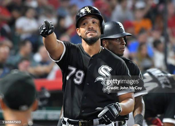 Jose Abreu points to the fans as he enters the dugout after hitting a two run home run in the fourth inning against the Los Angeles Angels at Angel...