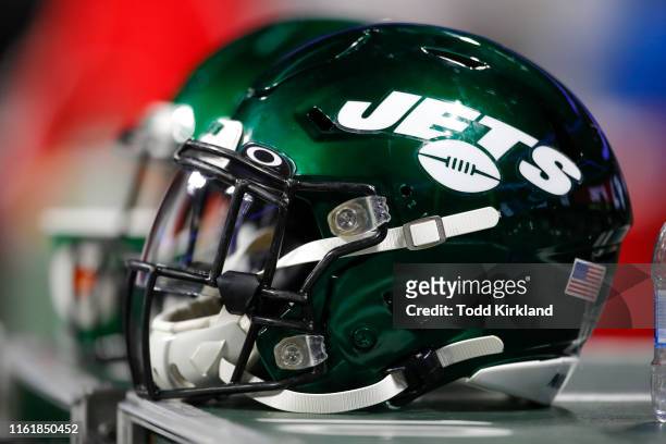New York Jets helmet sits on an equipment case during the second half of an NFL preseason game against the Atlanta Falcons at Mercedes-Benz Stadium...