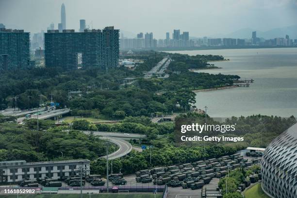 Trucks and armoured personnel vehicles park outside the Shenzhen Bay stadium on August 16, 2019 in Shenzhen, China. Pro-democracy protesters have...