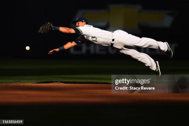 Tyler Saladino of the Milwaukee Brewers dives for a line drive during the first inning against the San Francisco Giants at Miller Park on July 13,...